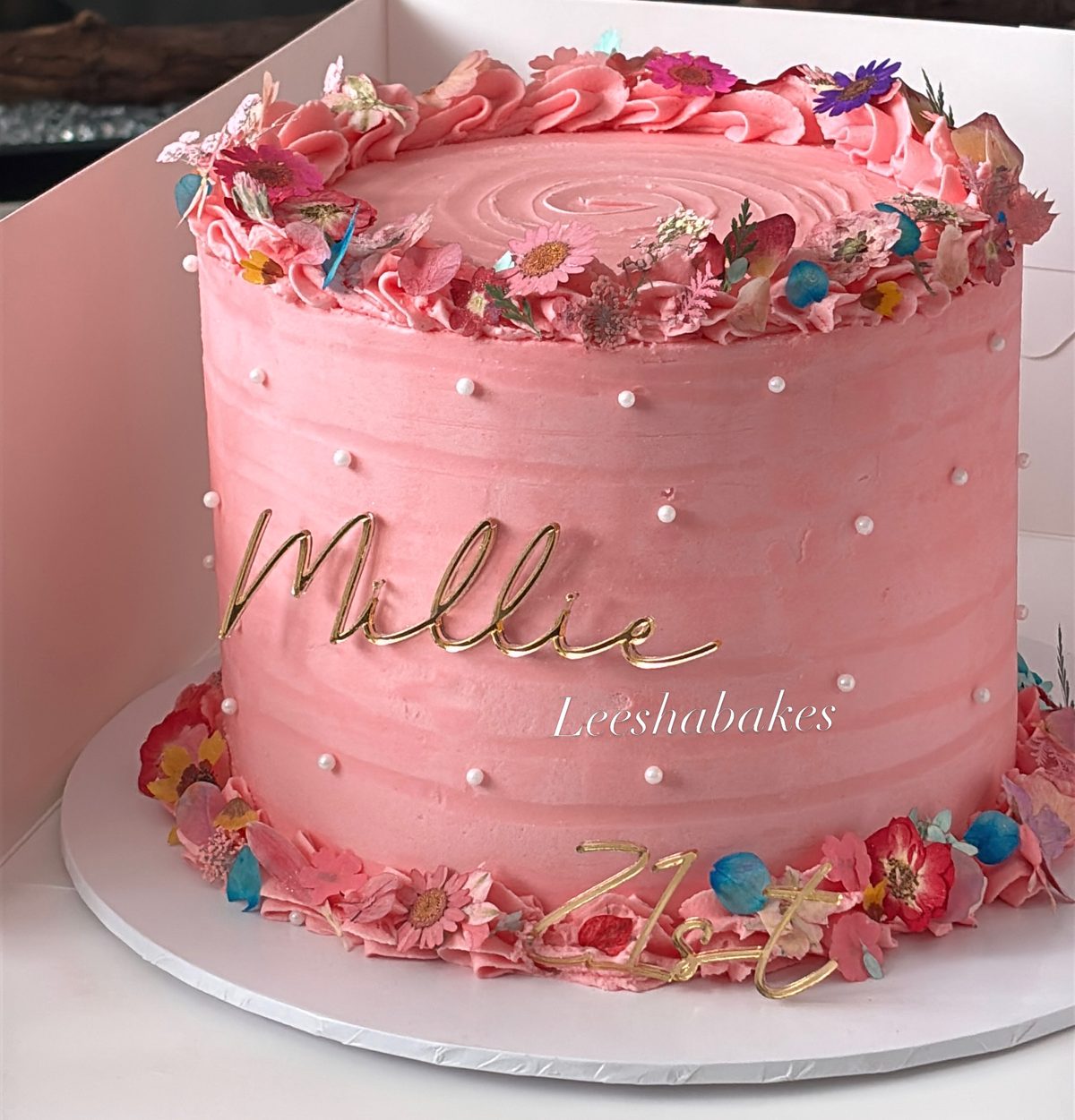 Pink cake with edible flowers for Millie