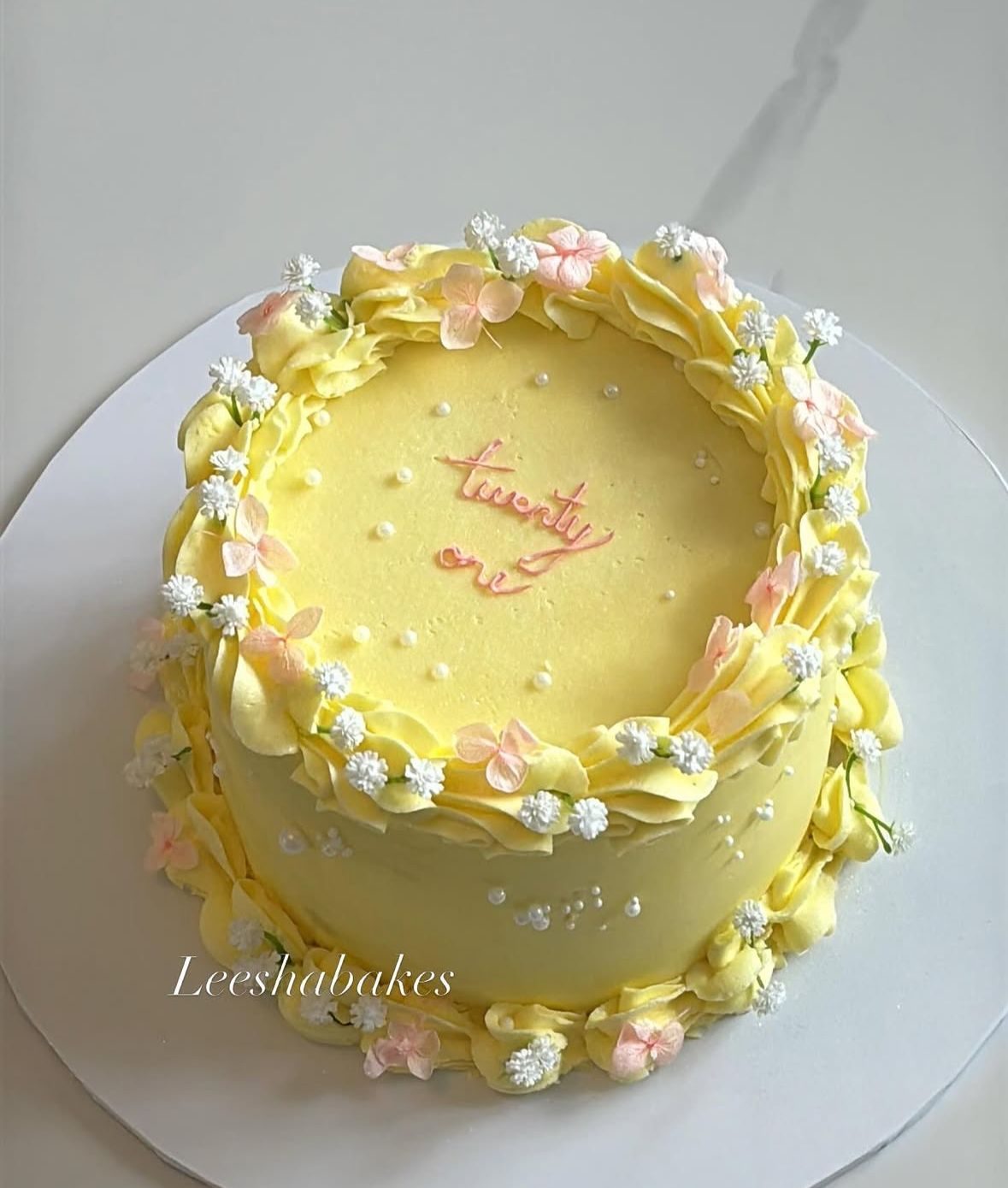 Pink heart cake with hearts and red ribbons