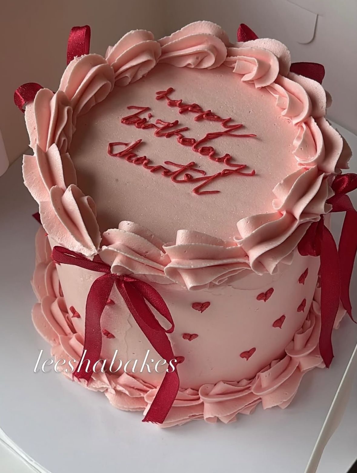 Cream heart cake with black bows