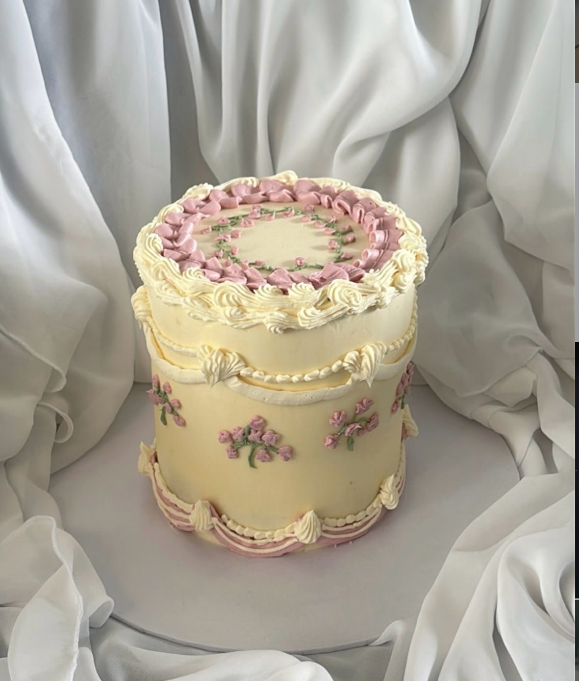 Tall vintage cream cake with pink flowers