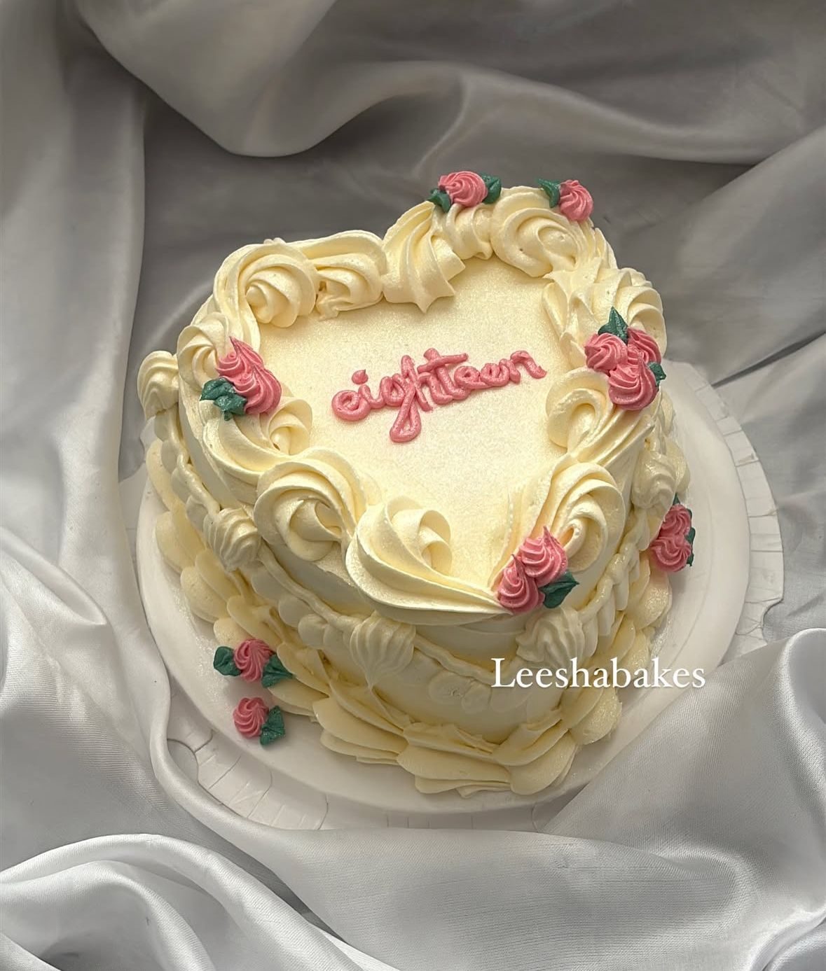 Cream heart cake with pink roses