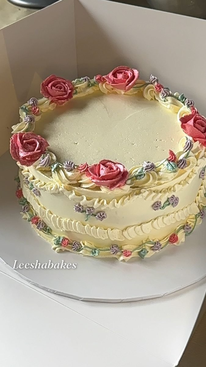 Cream vintage cake with pink roses and lilac rosebuds