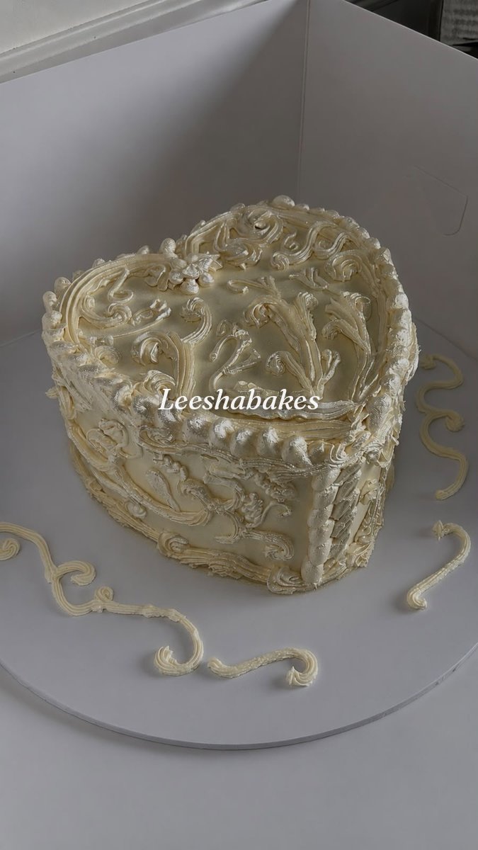 Ivory heart cake with intricate vintage piping