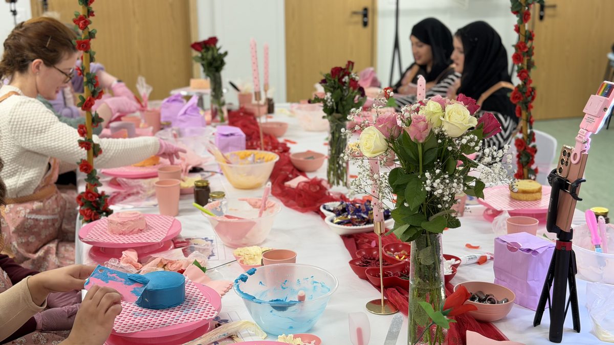 Workshop in full swing with floral arch and attendees
