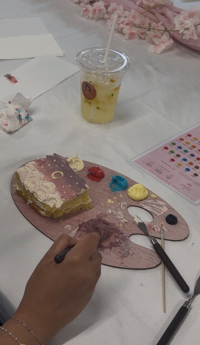 Painting buttercream onto a cake with a palette knife and full colour palette
